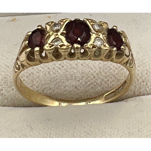 509 - A 9 carat gold ring set with garnets and diamonds. Size O/P. Weight 2gm.