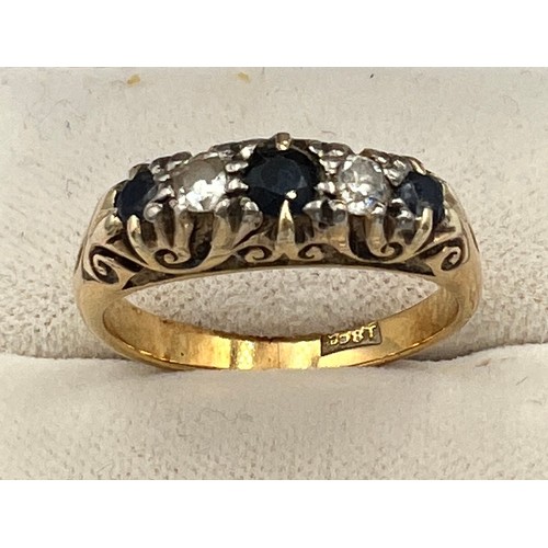 512 - An 18 carat gold ring set with sapphires and diamonds. Size O. Weight 5.5gm.