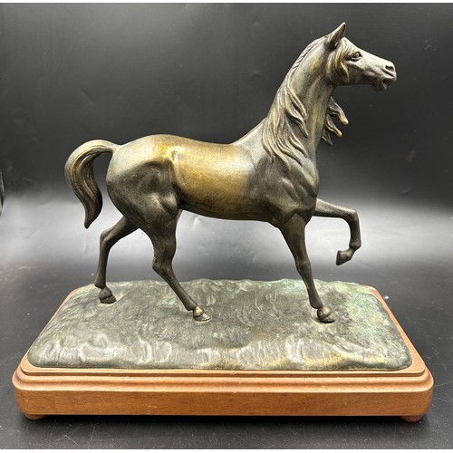 1034 - A bronze horse on a plinth 34cm h, plinth 36.5cm w x 17cm d. No markings.