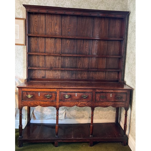 124 - A Georgian oak dresser with three drawers to the front and ivory escutcheons. 194cm h x 154cm w x 41... 