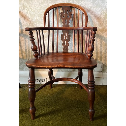 125 - A 19thC yew wood windsor chair with crinoline stretcher. 92cm h to back.