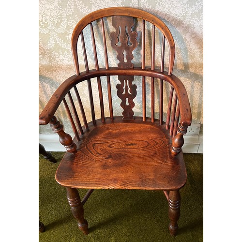 125 - A 19thC yew wood windsor chair with crinoline stretcher. 92cm h to back.