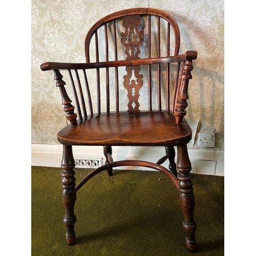 126 - A 19thC yew wood windsor chair with crinoline stretcher. 91cm h to back.