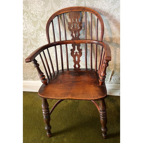 126 - A 19thC yew wood windsor chair with crinoline stretcher. 91cm h to back.