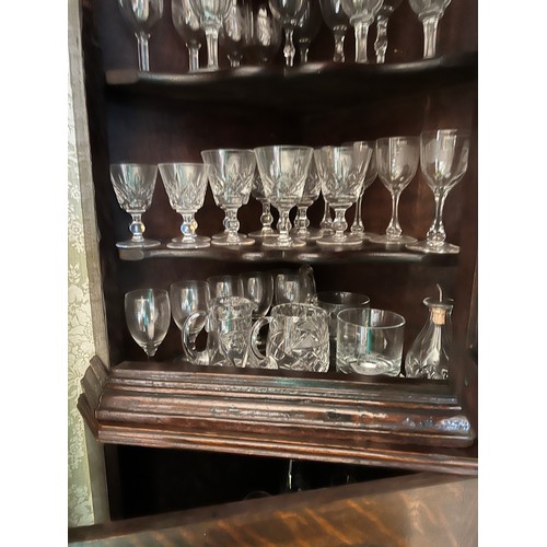 127 - A 19thC double height oak corner cupboard on bracket feet. 205cm h x 60cm w. (glasses not included)