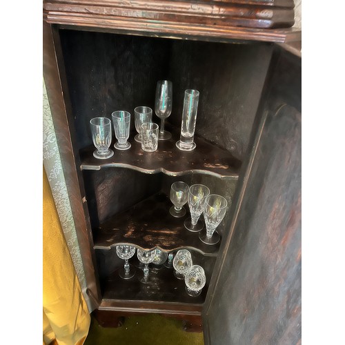 127 - A 19thC double height oak corner cupboard on bracket feet. 205cm h x 60cm w. (glasses not included)