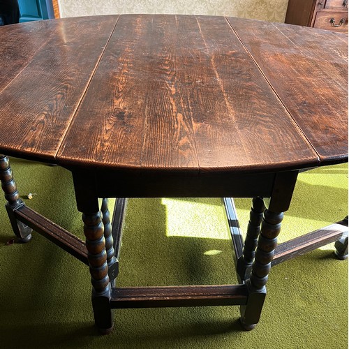 134 - An oak gateleg dining table with bobbin turned legs. 151cm w x 190cm l x 74cm h.