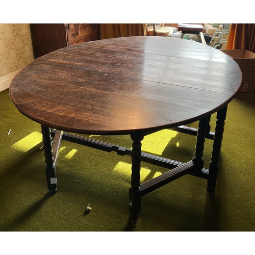 134 - An oak gateleg dining table with bobbin turned legs. 151cm w x 190cm l x 74cm h.