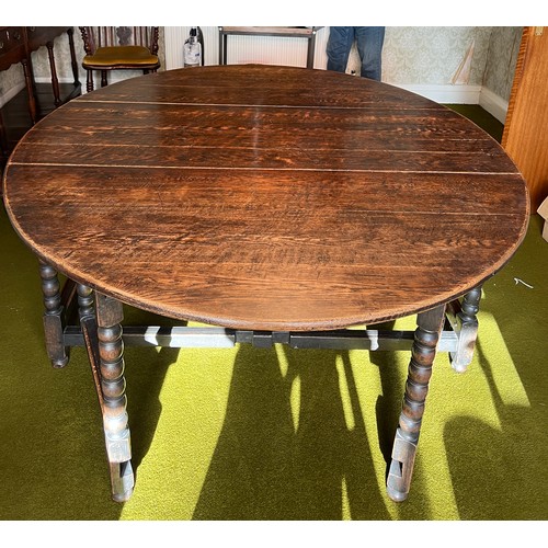 134 - An oak gateleg dining table with bobbin turned legs. 151cm w x 190cm l x 74cm h.