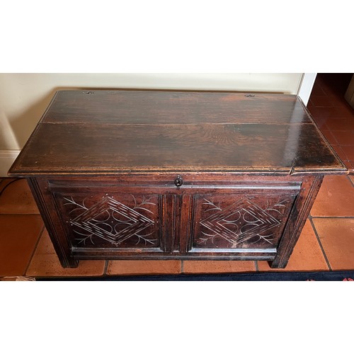 42 - An 18thC oak kist with decoration to the front. 102cm w x 49cm d x 55cm h.