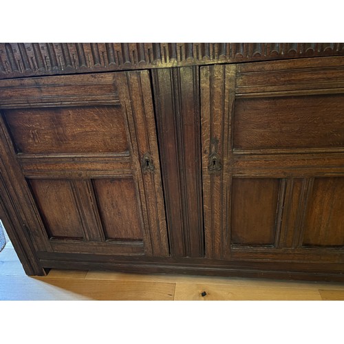 45 - An oak court cupboard with carving to the top, MA 1698. 138cm w x 57cm d x 151cm h.
Top shows signif... 