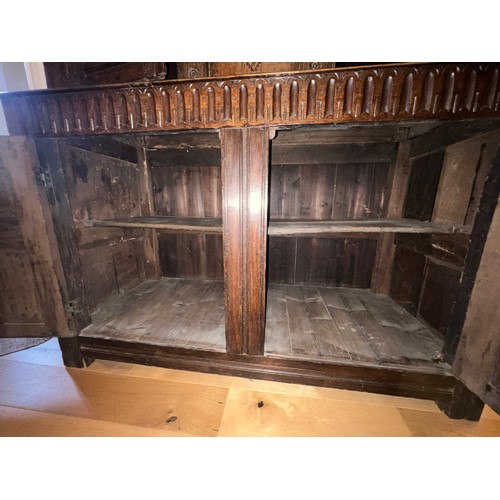 45 - An oak court cupboard with carving to the top, MA 1698. 138cm w x 57cm d x 151cm h.
Top shows signif... 