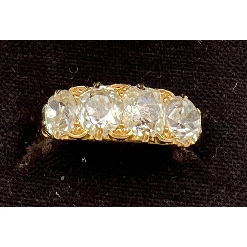 432 - A Victorian 18 carat gold ring set with four old cut diamonds. Total weight of diamonds approximatel... 