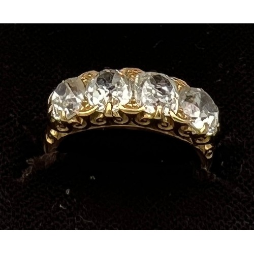 432 - A Victorian 18 carat gold ring set with four old cut diamonds. Total weight of diamonds approximatel... 