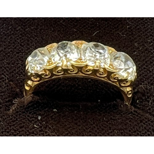 432 - A Victorian 18 carat gold ring set with four old cut diamonds. Total weight of diamonds approximatel... 