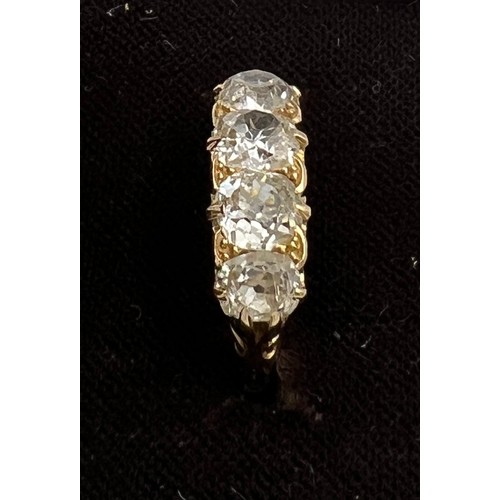 432 - A Victorian 18 carat gold ring set with four old cut diamonds. Total weight of diamonds approximatel... 