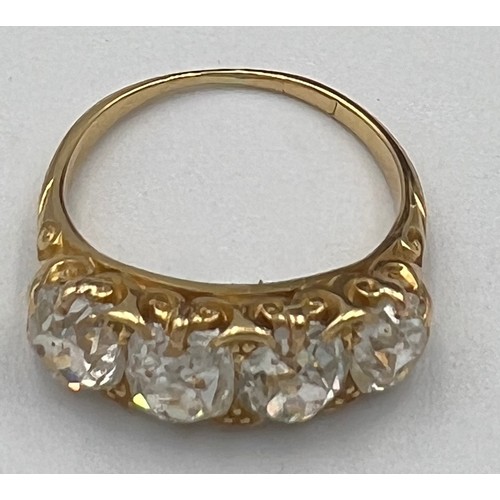 432 - A Victorian 18 carat gold ring set with four old cut diamonds. Total weight of diamonds approximatel... 