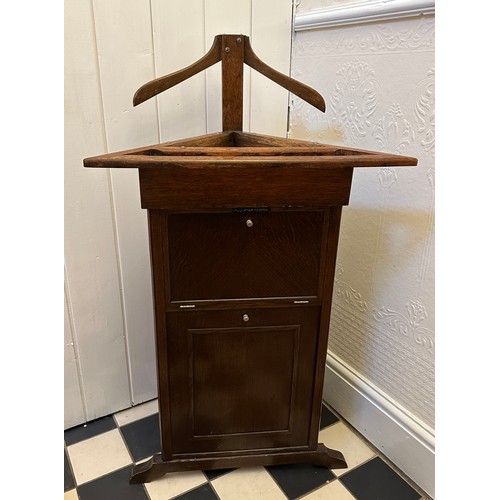 49 - A valet butler stand of triangular form. 106 x 58cm w x 39cm d.