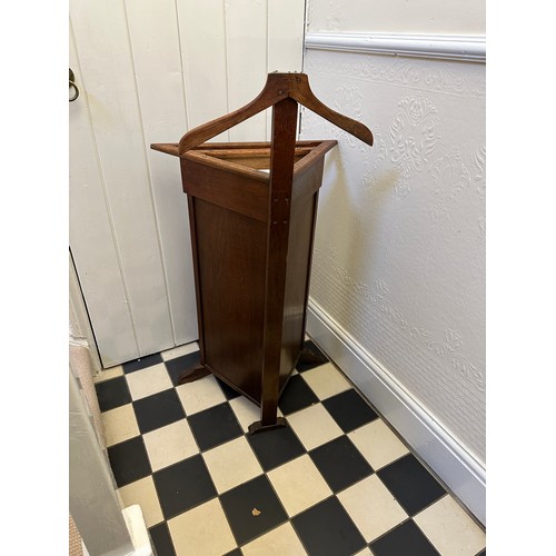 49 - A valet butler stand of triangular form. 106 x 58cm w x 39cm d.