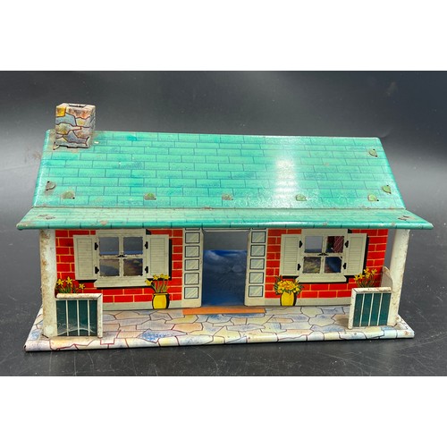 814 - A vintage tin plate dolls house, 28cm l x 18cm w x 13cm h. and various plastic dolls house furniture... 