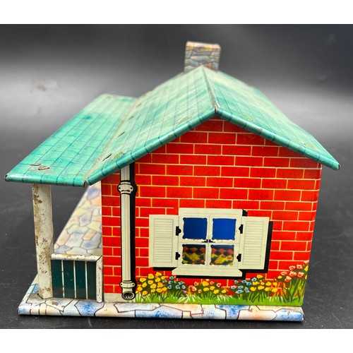 814 - A vintage tin plate dolls house, 28cm l x 18cm w x 13cm h. and various plastic dolls house furniture... 