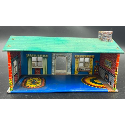 814 - A vintage tin plate dolls house, 28cm l x 18cm w x 13cm h. and various plastic dolls house furniture... 