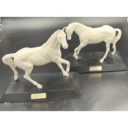 157 - Two Beswick white horses, 24cm h, on wooden plinths. “Spirit of Youth” and “ Spirit of the Wind”.