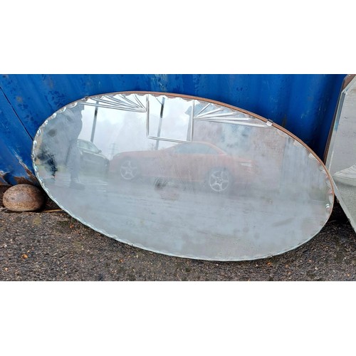 1009 - Two vintage bevelled glass mirrors, one oval 66cm x 38cm.