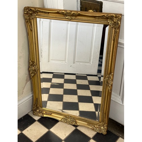 1011 - A heavy gilt framed bevelled mirror. 63 x 89cm.