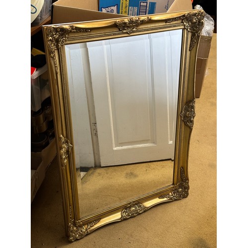 1011 - A heavy gilt framed bevelled mirror. 63 x 89cm.