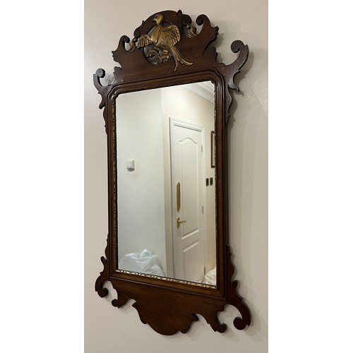 1010 - A mahogany and giltwood fretted wall mirror. 87cm h x 49cm w.