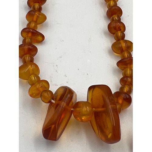 431 - Two strings of amber bead necklaces. Total weight 38.3gm. Approximate lengths 40cm and 50cm.