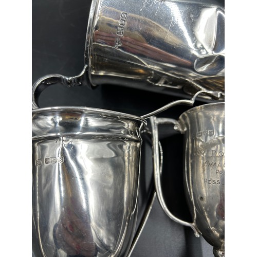 675 - Three hallmarked silver presentation cups. Various dates and makers to include Chester 1939. Total w... 