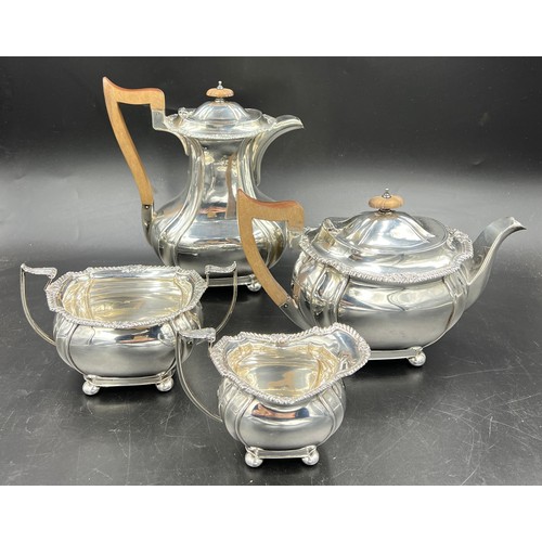 668 - A four piece hallmarked silver tea service with wooden handles and knops. Sheffield 1925, maker John... 