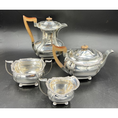 668 - A four piece hallmarked silver tea service with wooden handles and knops. Sheffield 1925, maker John... 