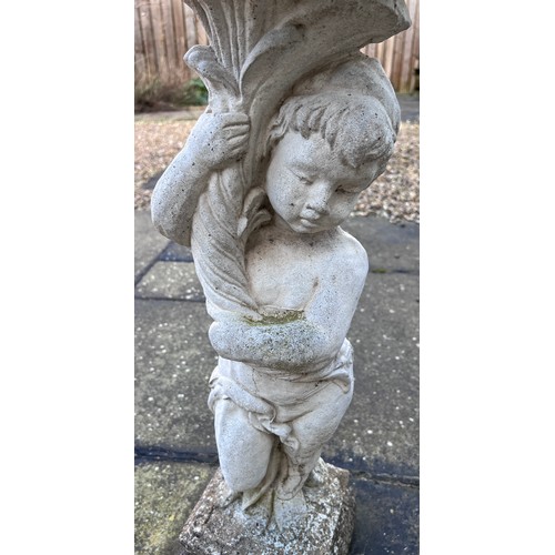 150 - A reconstituted stone bird bath with cherub base. 89cm h.