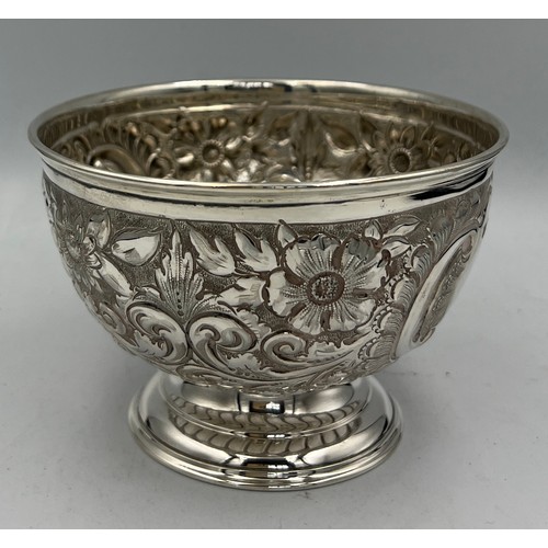 677 - A hallmarked silver bowl with embossed decoration and a vacant cartouche. Sheffield 1899, maker Fent... 