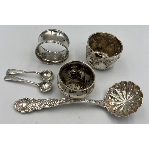 678 - Silver to include napkin ring, salt, pair of salt spoons, small bowl and a sifter spoon, London 1897... 