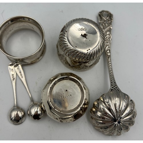 678 - Silver to include napkin ring, salt, pair of salt spoons, small bowl and a sifter spoon, London 1897... 