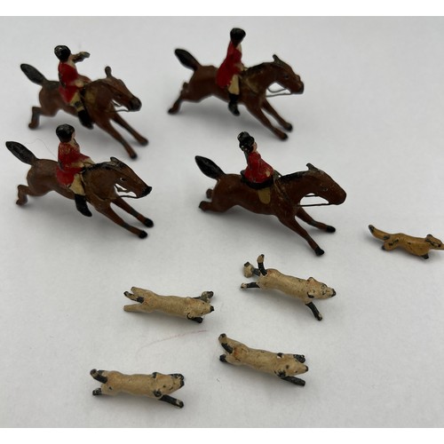 813 - Lead hunting figures to include four horses, four dogs and a fox. Horses approximately 4cm l.