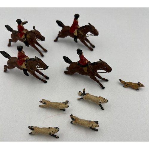 813 - Lead hunting figures to include four horses, four dogs and a fox. Horses approximately 4cm l.