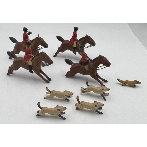 813 - Lead hunting figures to include four horses, four dogs and a fox. Horses approximately 4cm l.