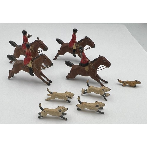 813 - Lead hunting figures to include four horses, four dogs and a fox. Horses approximately 4cm l.