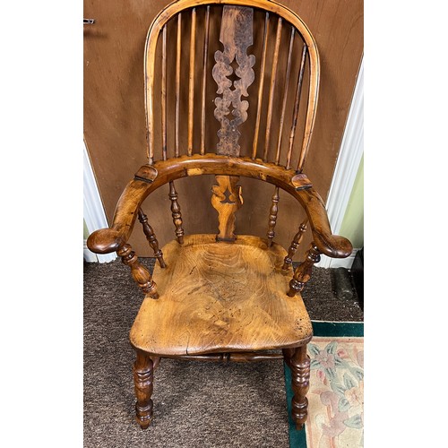 13 - A high backed yew wood Windsor broad arm chair. 110 cm h to back. Bearing name to underside W. Thack... 