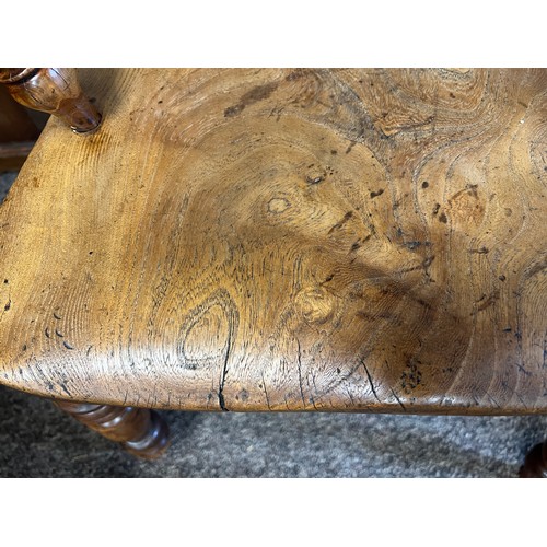 13 - A high backed yew wood Windsor broad arm chair. 110 cm h to back. Bearing name to underside W. Thack... 