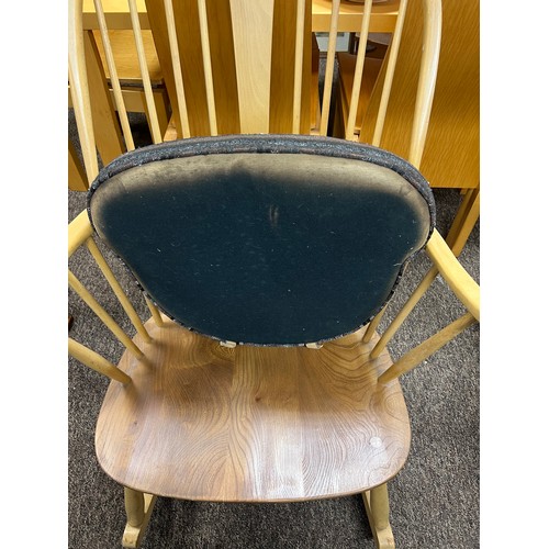 14 - Ercol ‘Chairmaker’ rocking chair with gold lable and original cushions. 104cm h to back.