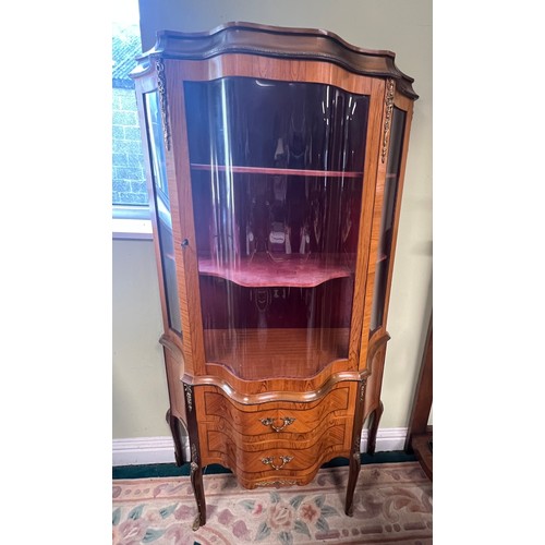 16 - A mahogany inlaid and brass mounted vitrine with central door and shaped glass panels. Two drawers t... 