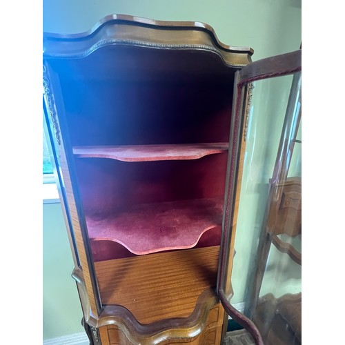 16 - A mahogany inlaid and brass mounted vitrine with central door and shaped glass panels. Two drawers t... 