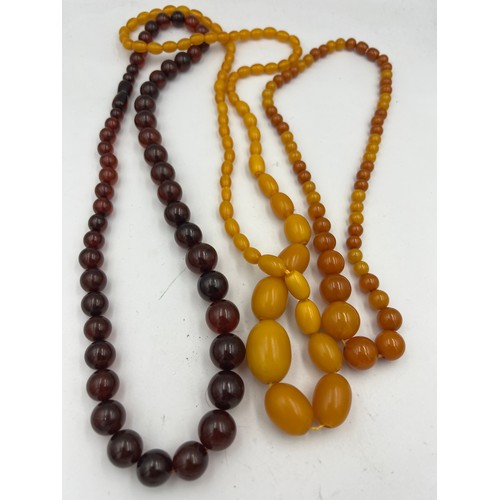 428 - Three strings of amber coloured bead necklaces.