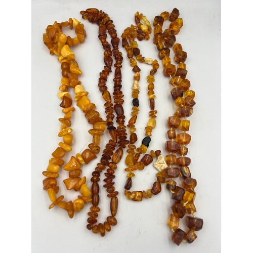 429 - Four amber coloured bead necklaces.